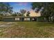 Single story home with a large manicured front yard at dusk at 9819 Allen Rd, Lithia, FL 33547