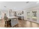 Modern kitchen with gray cabinets, stainless steel appliances, and a spacious island with seating and views to the backyard at 9819 Allen Rd, Lithia, FL 33547