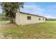 Side view of metal outbuilding in the yard with a tree to the left at 9819 Allen Rd, Lithia, FL 33547
