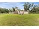 Outbuilding with gravel, grass and view of the home in background at 9819 Allen Rd, Lithia, FL 33547