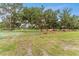 Green metal gate leading to pasture, horses and cows at 9819 Allen Rd, Lithia, FL 33547