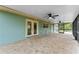 Covered patio with ceiling fans, overlooking a spacious backyard with lush landscaping at 9819 Allen Rd, Lithia, FL 33547