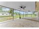 Large screened patio with tiled floors overlooks a spacious backyard at 9819 Allen Rd, Lithia, FL 33547