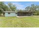 View of the home's rear with screened lanai overlooking the backyard at 9819 Allen Rd, Lithia, FL 33547