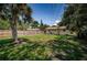 The backyard of this home is large with a wood fence, grass and a shed-like outbuilding at 8184 49Th N Ave, St Petersburg, FL 33709