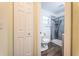 Bathroom view featuring modern shower with glass doors and stylish blue accent panel at 8184 49Th N Ave, St Petersburg, FL 33709