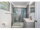 Updated bathroom featuring modern shower with glass doors and stylish blue accent panel at 8184 49Th N Ave, St Petersburg, FL 33709