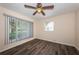 Bedroom with windows for natural light, ceiling fan, and wood-look flooring at 8184 49Th N Ave, St Petersburg, FL 33709