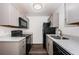 Close up of kitchen with stainless steel appliances and gray cabinets at 8184 49Th N Ave, St Petersburg, FL 33709