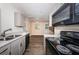 View of kitchen with stainless steel appliances flowing into the living area at 8184 49Th N Ave, St Petersburg, FL 33709