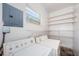 This laundry room features a washer, dryer, water heater, and storage shelves at 8184 49Th N Ave, St Petersburg, FL 33709
