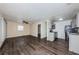 Open living area with dark wood floors and view to the kitchen with stainless steel appliances at 8184 49Th N Ave, St Petersburg, FL 33709