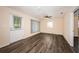 Open living room featuring modern flooring, a ceiling fan, and natural light from two windows at 8184 49Th N Ave, St Petersburg, FL 33709