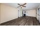 Open living area with dark wood floors and view to the kitchen with stainless steel appliances at 8184 49Th N Ave, St Petersburg, FL 33709
