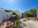 Outdoor seating area in a private backyard with a lovely patio and lush landscaping under a beautiful sky at 7516 S Mascotte St, Tampa, FL 33616