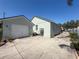 Exterior of the property showing a garage and back entrance with ample parking space at 7516 S Mascotte St, Tampa, FL 33616