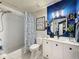Well-appointed bathroom with a shower-tub, modern vanity, and artistic decor creating a relaxing and functional space at 7516 S Mascotte St, Tampa, FL 33616
