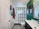 Stylish bathroom featuring a glass shower, modern vanity, and unique wall decor adding character and charm at 7516 S Mascotte St, Tampa, FL 33616
