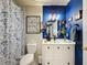 Bright bathroom featuring a shower-tub, vanity with a stylish mirror, and artistic decor creating a modern, inviting space at 7516 S Mascotte St, Tampa, FL 33616