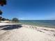 Calm beach view with clear, shallow water, perfect for a peaceful day at Picnic Island Park at 7516 S Mascotte St, Tampa, FL 33616