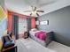 Stylish bedroom with modern color palette, a ceiling fan, and ample natural light creating a comfortable and inviting space at 7516 S Mascotte St, Tampa, FL 33616