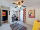 Bedroom featuring colorful rug, a wooden desk, and view to adjacent room at 7516 S Mascotte St, Tampa, FL 33616