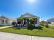Inviting home featuring a screened porch and lush front yard, perfect for relaxed living at 7516 S Mascotte St, Tampa, FL 33616