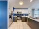 Kitchen with stainless steel appliances, custom cabinets and tiled floors at 7516 S Mascotte St, Tampa, FL 33616