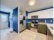 The kitchen is equipped with modern appliances, white countertops and a tile floor at 7516 S Mascotte St, Tampa, FL 33616