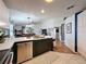 Bright open-concept kitchen featuring a spacious island, stainless steel appliances, and seamless flow into the dining and living areas at 7516 S Mascotte St, Tampa, FL 33616
