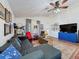 The open concept living room features vaulted ceilings, hardwood floors and an oversized couch at 7516 S Mascotte St, Tampa, FL 33616