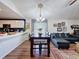 Open concept living area with dining table set and view of the living room sofa at 7516 S Mascotte St, Tampa, FL 33616
