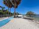 Expansive sandy beach at Picnic Island Park with clear waters and ample space to relax and enjoy at 7516 S Mascotte St, Tampa, FL 33616