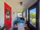 Covered porch area showcasing tile flooring, ceiling fan, and an inviting entryway at 7516 S Mascotte St, Tampa, FL 33616