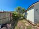 Side yard featuring lush landscaping and walkway at 7516 S Mascotte St, Tampa, FL 33616