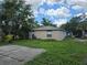 Rear exterior of the home surrounded by lush greenery, highlighting privacy and serenity at 1000 13Th S Ave, St Petersburg, FL 33705