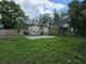 View of the home's fenced backyard area with a basketball hoop and a detached garage at 1000 13Th S Ave, St Petersburg, FL 33705