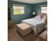 Comfortable bedroom featuring a cozy ottoman, natural light, and serene wall color at 10185 Santiago Ct, Seminole, FL 33776