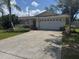 Charming single-story home featuring a spacious driveway and an attached two-car garage at 10185 Santiago Ct, Seminole, FL 33776