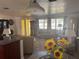Inviting living room area featuring a glass table with sunflower centerpiece, with easy access to other living spaces at 10185 Santiago Ct, Seminole, FL 33776