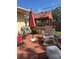 Backyard patio featuring an outdoor grill under a shaded cabana with patio furniture at 10185 Santiago Ct, Seminole, FL 33776