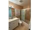 Clean bathroom featuring a vanity with storage, a toilet, and a shower/tub with sliding glass doors at 1020 85Th N Ave # 223, St Petersburg, FL 33702
