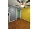 Comfortable bedroom with hardwood floors, a ceiling fan, closet, and a bright window at 1020 85Th N Ave # 223, St Petersburg, FL 33702