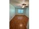 Bright bedroom with hardwood flooring, natural light, and a ceiling fan at 1020 85Th N Ave # 223, St Petersburg, FL 33702
