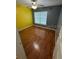 Bright bedroom featuring hardwood floors, a ceiling fan, and a bright window at 1020 85Th N Ave # 223, St Petersburg, FL 33702