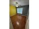 Comfortable bedroom featuring hardwood floors, a ceiling fan, and a bright window at 1020 85Th N Ave # 223, St Petersburg, FL 33702