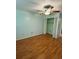 Cozy bedroom featuring a ceiling fan and spacious closet with bi-fold doors at 1020 85Th N Ave # 223, St Petersburg, FL 33702
