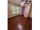 Cozy bedroom with hardwood floors, a ceiling fan, a closet, and a bright window at 1020 85Th N Ave # 223, St Petersburg, FL 33702