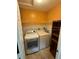 Convenient laundry area with a washer, dryer, shelving, and tiled floors at 1020 85Th N Ave # 223, St Petersburg, FL 33702