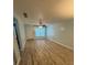 Bright living room with durable flooring, a ceiling fan, and a large window at 1020 85Th N Ave # 223, St Petersburg, FL 33702